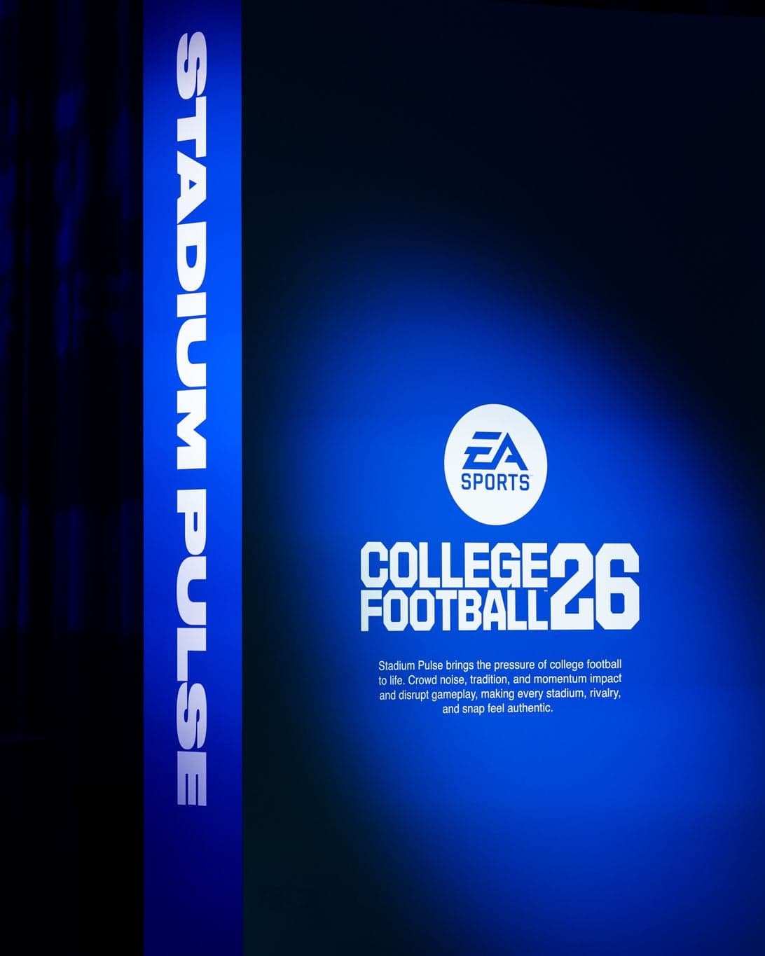 A Stadium Pulse wall with a College Football 26 sign glowing in a blue spotlight