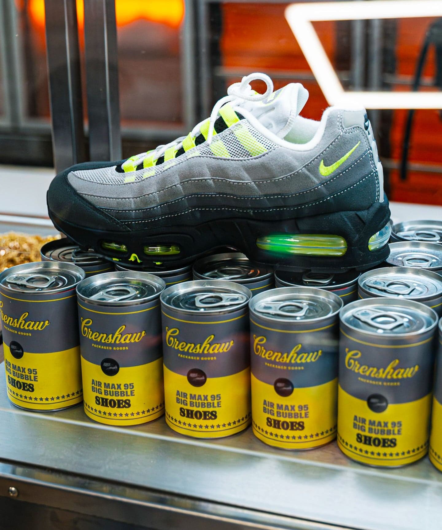 A Nike Air Max sneaker on top of a stack of branded food cans