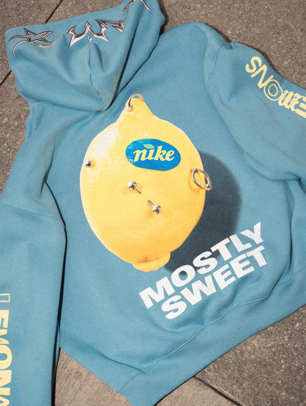 A blue hoodie printed with a lemon and the words “Mostly Sweet”